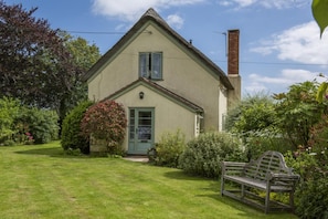 A house with a thatched roof, a chimney, and a front door. - 2 Bed in Weston (oc-a45906) (Weston)