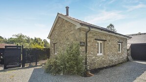 A stone building with a pitched roof, a chimney, and a small window. - 2 Bed in Llanwrthwl (oc-b45319) (Llanwrthwl)