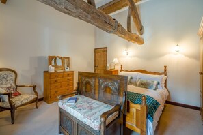 A bedroom with a wooden bed, a wooden dresser, a chair, and a nightstand. - 1 Bed in Ribchester (oc-n45957) (Ribchester)