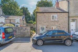 A stone building with a door and windows, parked cars, and a stone wall. - 1 Bed in Ribchester (oc-n45957) (Ribchester)