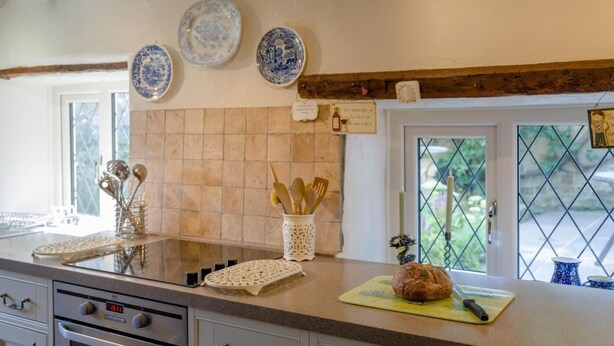 A kitchen with a large island, a stove, oven, and a window with a view. - 1 Bed in Ribchester (oc-n45957) (Ribchester)