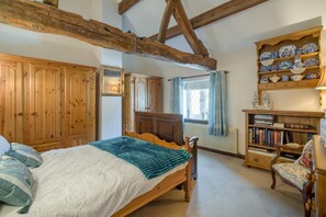 A bedroom with a wooden bed, a wardrobe, a bookshelf, and a window with curtains. - 1 Bed in Ribchester (oc-n45957) (Ribchester)