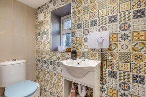 A bathroom with a toilet, sink, and a window. - 2 Bed in Crow (oc-h45921) (Ringwood)