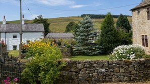 A rural landscape with stone walls, a stone house, and a coniferous tree. - 2 Bed in Bolton By Bowland (oc-m45938) (Grindleton)