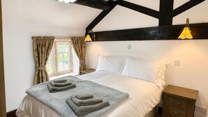 A bedroom with a bed, bedside tables, a window with curtains, and a ceiling with exposed beams. - 2 Bed in Bolton By Bowland (oc-m45938) (Grindleton)