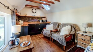 A cozy kitchen with a lofted sleeping area, wooden beams, and a view through a skylight. - 1 Bed in Botus Fleming (oc-f45947) (Botusfleming)
