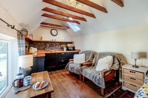 A cozy kitchen with a lofted sleeping area, wooden beams, and a view through a skylight. - 1 Bed in Botus Fleming (oc-f45947) (Botusfleming)