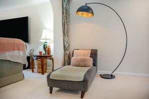 A bedroom with a bed, a floor lamp, a side table with a lamp, a decorative vase, and a television on the wall. - 3 Bed in Christchurch (oc-m45917) (Christchurch)
