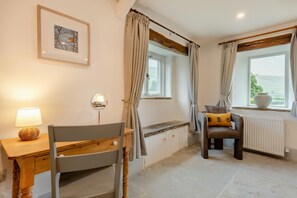 A room with a wooden desk, chair, and a view of the sea through a window. - 3 Bed in Litton (oc-e45988) (Litton)