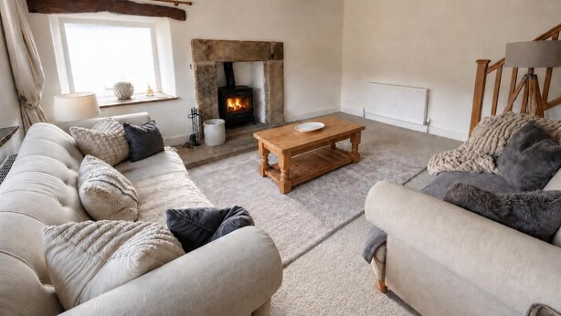 A cozy living room with a fireplace, a sofa, a coffee table, and a lamp. - 3 Bed in Litton (oc-e45988) (Litton)