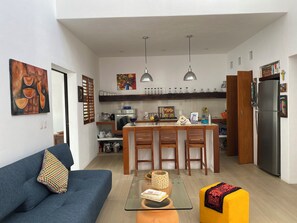 A modern kitchen with a central island, bar stools, and a refrigerator. - CENTRAL PRIVATE HOME WITH PRIVATE POOL, 3 BLOCKS FROM THE MALECON (Cozumel)
