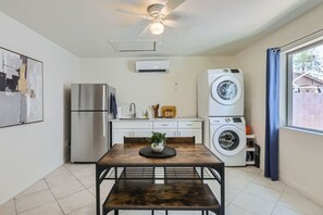 A compact kitchen with a refrigerator, a washing machine, and a ceiling fan. - Charming 1-BR, 1-Bath Casita PHX (Phoenix)