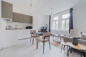 A modern living space with a kitchen, dining area, and seating area. - Blueground | Prague 10, fully equipped & nr park (PRG-24) (Prague)
