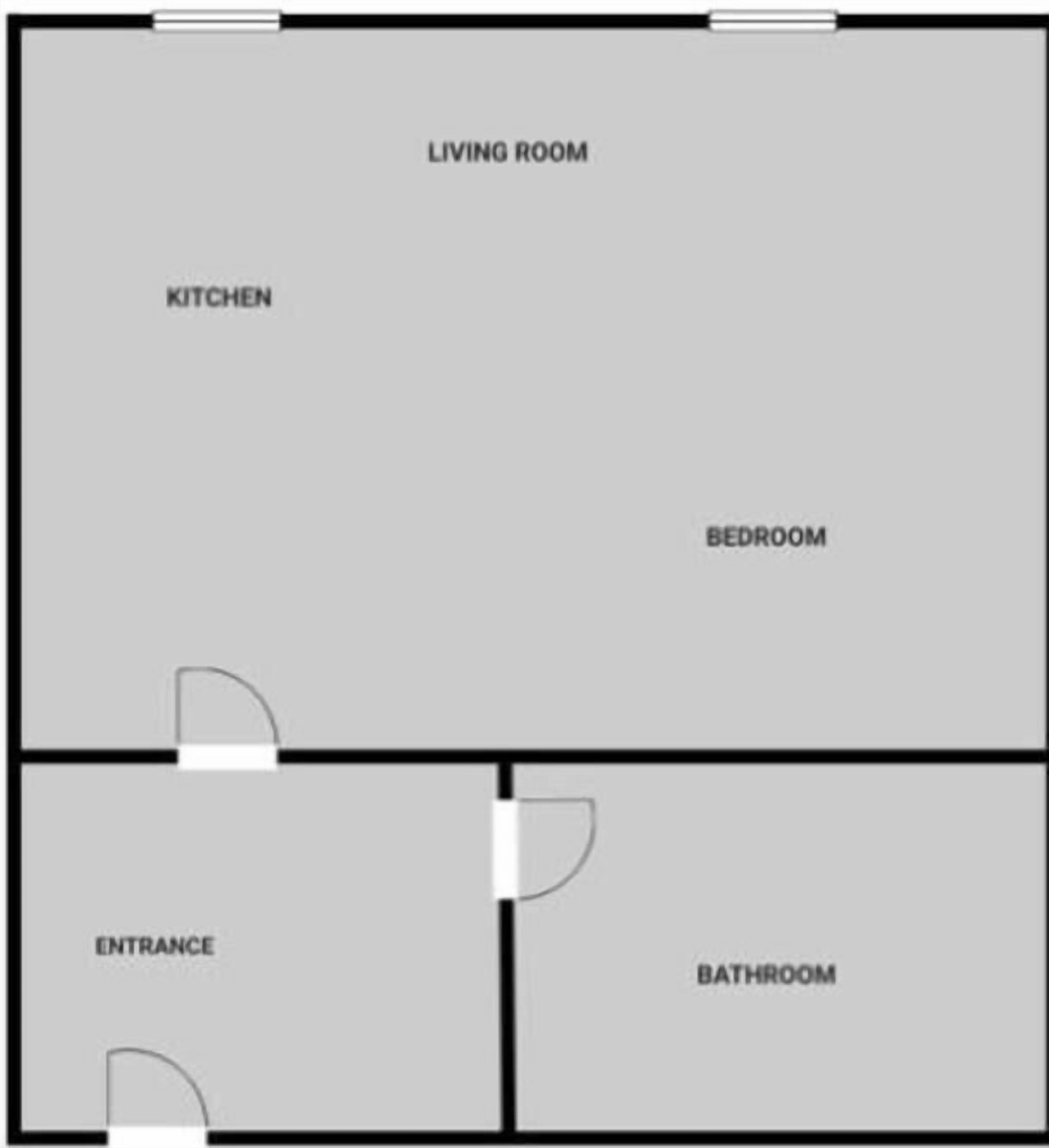 Un plan d’étage comprenant un salon, une cuisine, une chambre, une entrée et une salle de bain.