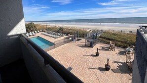 A pool area with lounge chairs and a view of the beach. - Oceanfront, steps to the surf!
Boardwalk attractions and the airport nearby! (Myrtle Beach)
