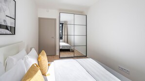 Een hotelkamer met een bed, een kledingkast en een spiegel.