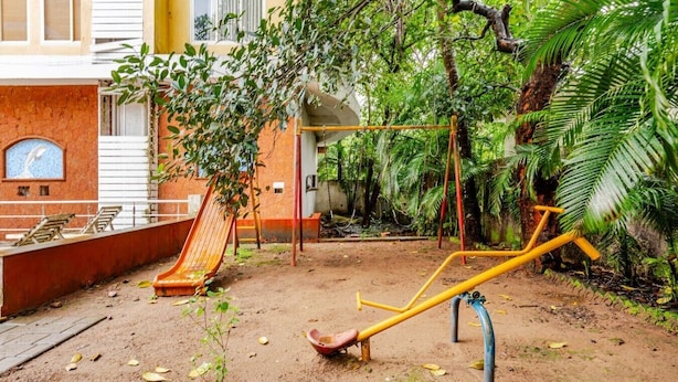 A playground with a slide, swings, and exercise equipment.