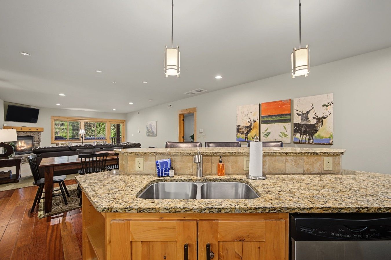 A modern kitchen with granite countertops, stainless steel appliances, and a central island.