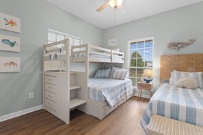 A child's bedroom with bunk beds, a desk, and a window with blinds. - The Camp at Timber Ridge - Direct Water Access (Pass Christian)
