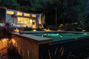 A modern house with a swimming pool, wooden deck, and outdoor lighting. - Topanga Canyon Oasis - 3 Homes & Pool - C&C | 12 (Topanga)