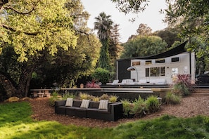 A modern house with a patio, outdoor seating, and a garden. - Topanga Canyon Oasis - 3 Homes & Pool - C&C | 12 (Topanga)