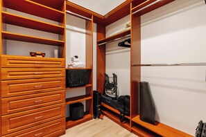 A walk-in closet with multiple wooden drawers, shelves, and hanging space. - Topanga Canyon Oasis - 3 Homes & Pool - C&C | 12 (Topanga)