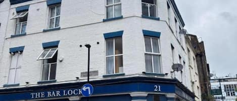 A building with a sign reading 'THE BAR LOCK' and the number 21.