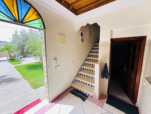 A staircase with patterned steps leading to a room with a door. - Villa Targante, Essaouira (Essaouira)