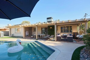 A residential property with a swimming pool, outdoor seating, and a pergola. - Backdrop - Private Pool - Mins to Old town (Scottsdale)