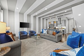 A modern living room with a sofa, armchairs, and a coffee table. - City View Rooftop Retreat w/ FirePit • Close to DT (Nashville)