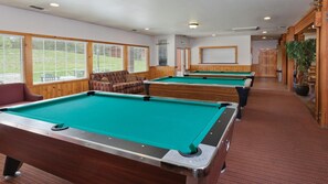 A pool hall with multiple pool tables, wooden walls, and a red carpeted floor. - Big Bear Ski & Lake Retreat, WorldMark 2BR Suite w/ Fireplace & Hot Tub (Big Bear Lake)