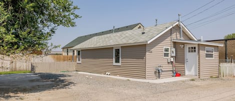 A single-story building with a gabled roof, a front door, and a small window.
