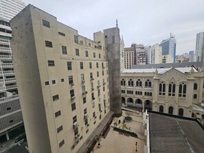 A multi-story building with a central courtyard, surrounded by other buildings. - Estúdio Charme Urbano - Consolação (São Paulo)
