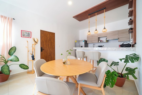 A modern kitchen with wooden cabinets, a built-in oven, and a countertop.
