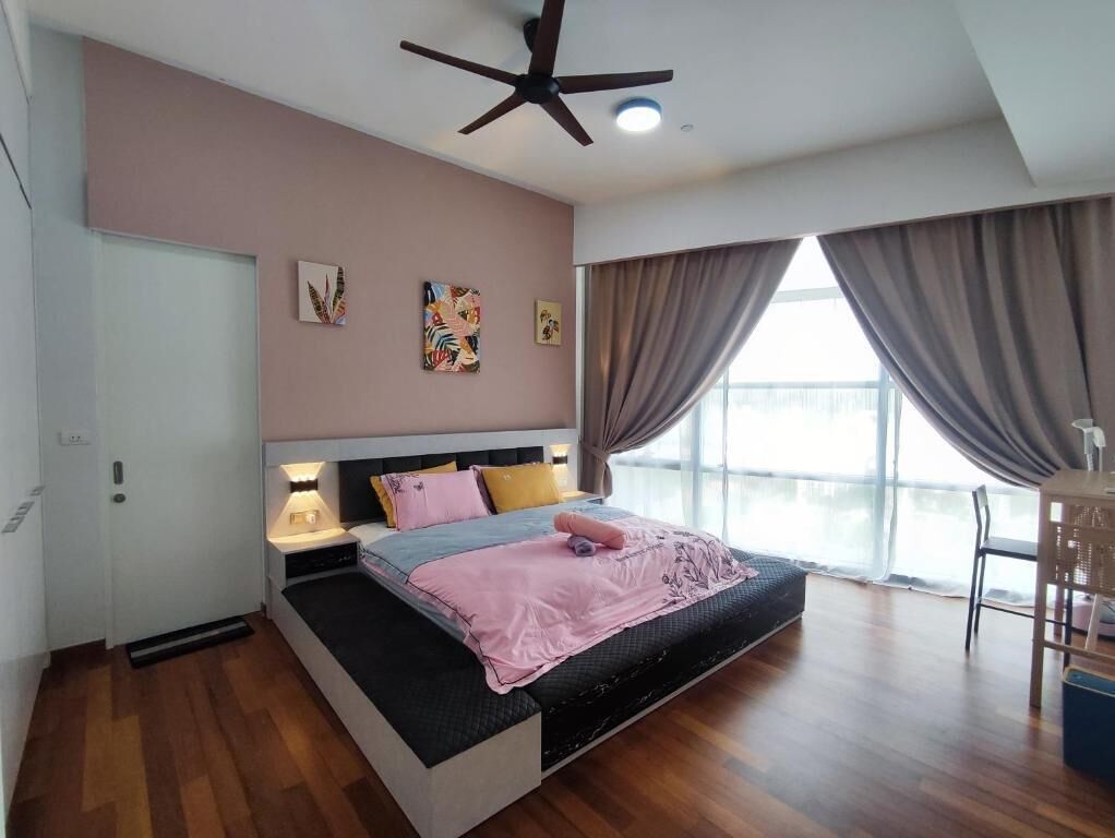 A modern bedroom with a bed, bedside lamps, a ceiling fan, and a view of the outdoors.
