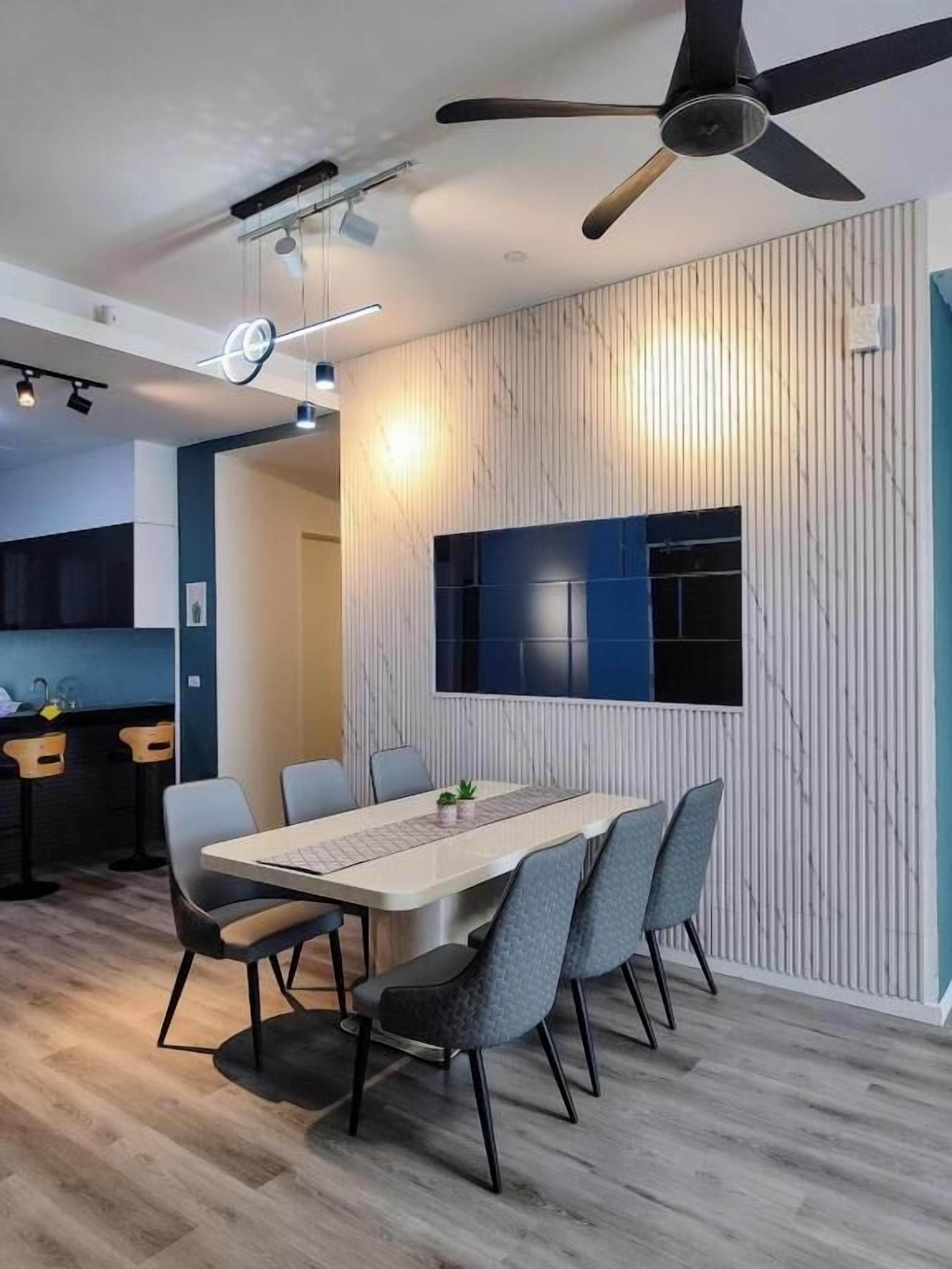 A modern dining area with a long table, chairs, and a ceiling fan.