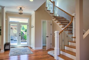 A staircase with wooden steps and black balusters, leading to an upper floor.