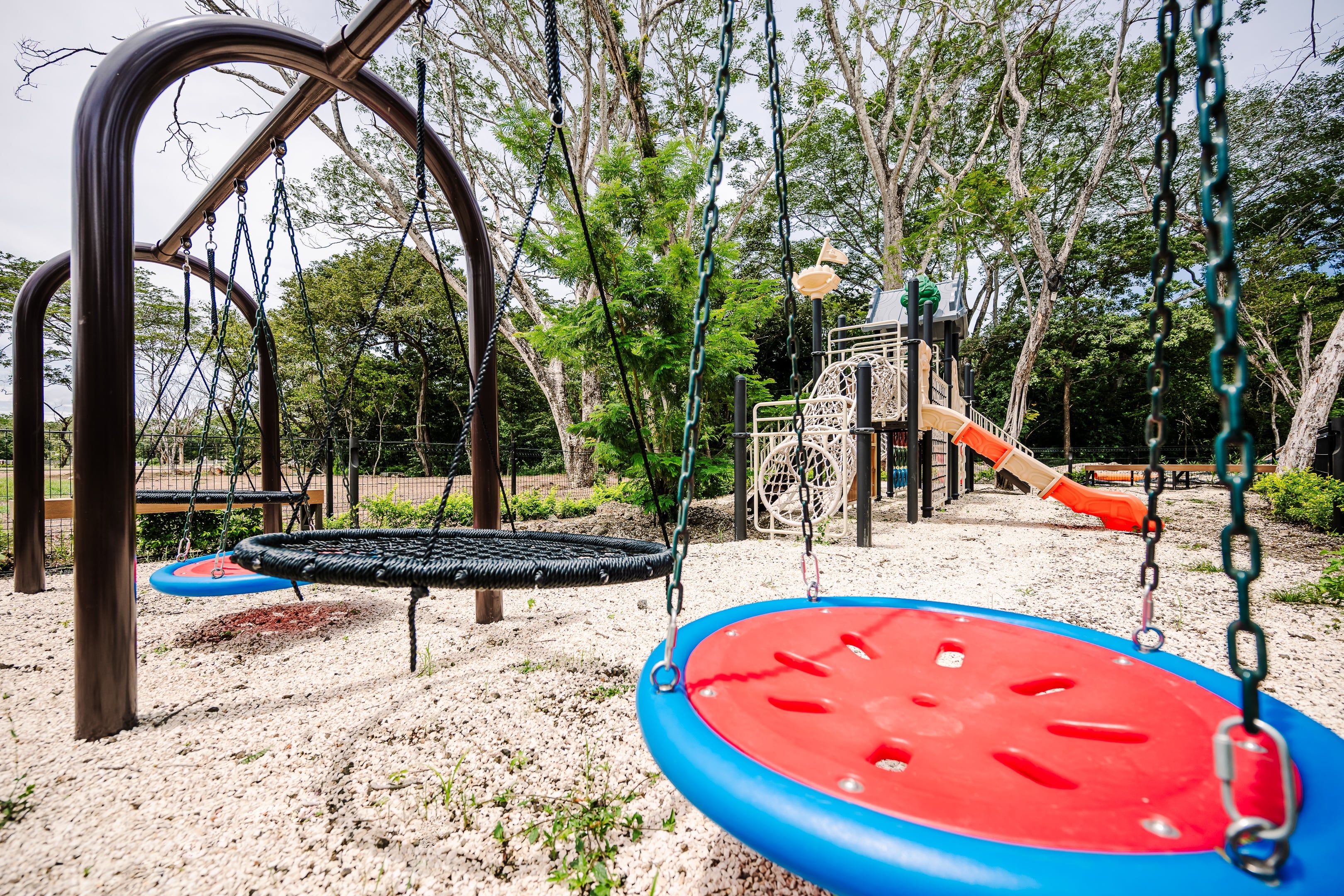 A playground with swings and a slide.