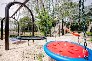 A playground with swings and a slide.