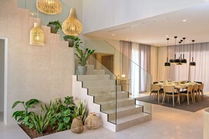 A modern interior with a staircase, dining area, and hanging lights. - Villa Rijeka, Private villa with pool, Hvar Island (Hvar)