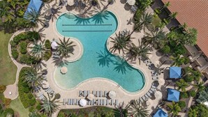 An aerial view of a resort with a large swimming pool, sun loungers, and palm trees. - 3 bed house in Esplanade Lakewood Ranch Bradenton with private POOL and GOLF (Bradenton)