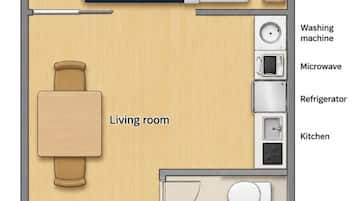 Distribución de una habitación de hotel con dos camas, sala de estar, cocina y baño, además de una entrada.
