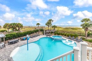 A swimming pool with a hot tub, lounge chairs, and a view of the beach. - Sea Y'all Soon - Oceanfront in Garden City Beach (Garden City Beach)