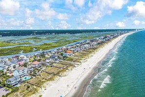 A coastal residential area with houses along the beach, a clear sky, and a view of the ocean. - Sea Y'all Soon - Oceanfront in Garden City Beach (Garden City Beach)