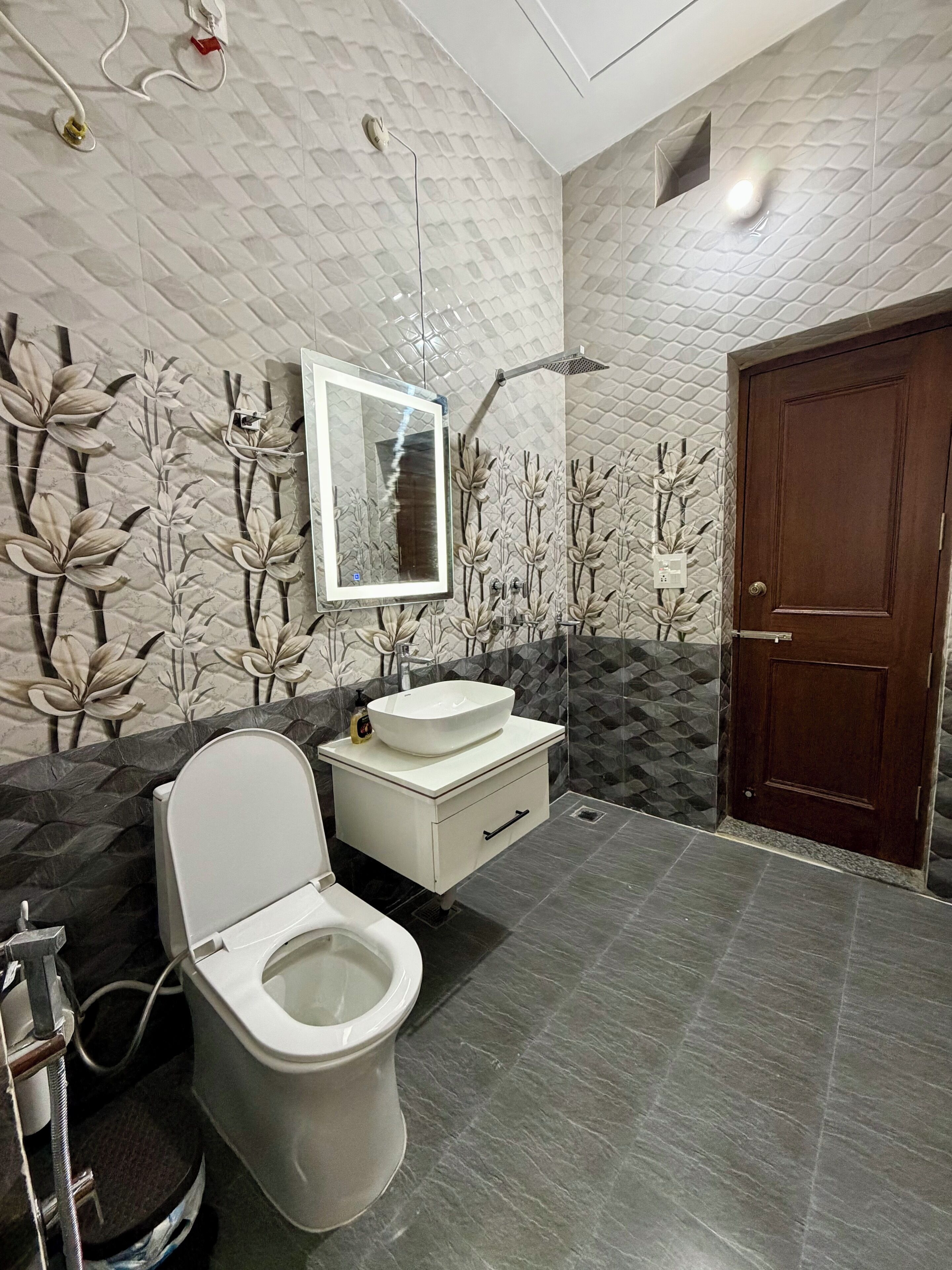 A bathroom with a toilet, sink, and shower.