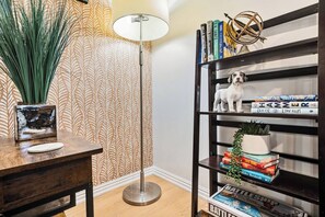 A bookshelf with books, a small dog figurine, and a decorative plant. - *New* Gorgeous Space w/Big Rooms, Perfect Location - Apartment (Millcreek)