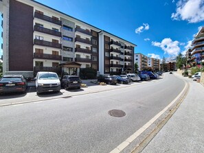 A multi-story parking garage with cars parked on both sides. - Les Ambassadeurs B 3 by Interhome (Crans-Montana)
