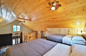 A room with two beds, a desk, and a ceiling fan. - Brook Side Cabin (Crosslake)