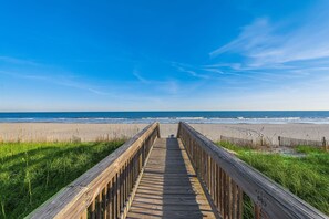 A wooden boardwalk leading to a beach with a clear blue sky. - Oceanfront Penthouse, Pool, Lazy River & Waterpark (North Myrtle Beach)