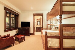 A bedroom with a wooden bunk bed, a television, a desk with a chair, and a window. - Ski-In/Ski-Out 6BR Luxury Estate with Indoor Pool, Hot Tub & Theater at The Colony, Sleeps 26 (Park City)